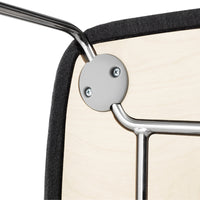 Close-up of sleek metal frame with black upholstery and natural wood accents, showcasing modern design and craftsmanship.
