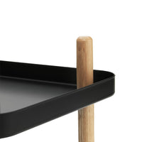 Black tray with smooth edges and a natural wooden leg, featuring minimalist design elements.