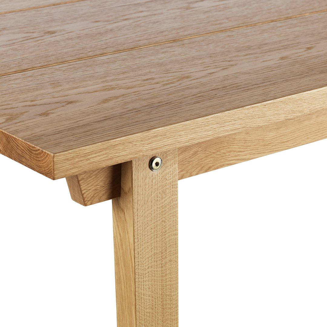 Light oak wood table with a natural grain pattern and smooth surface, showcasing a minimalist design.