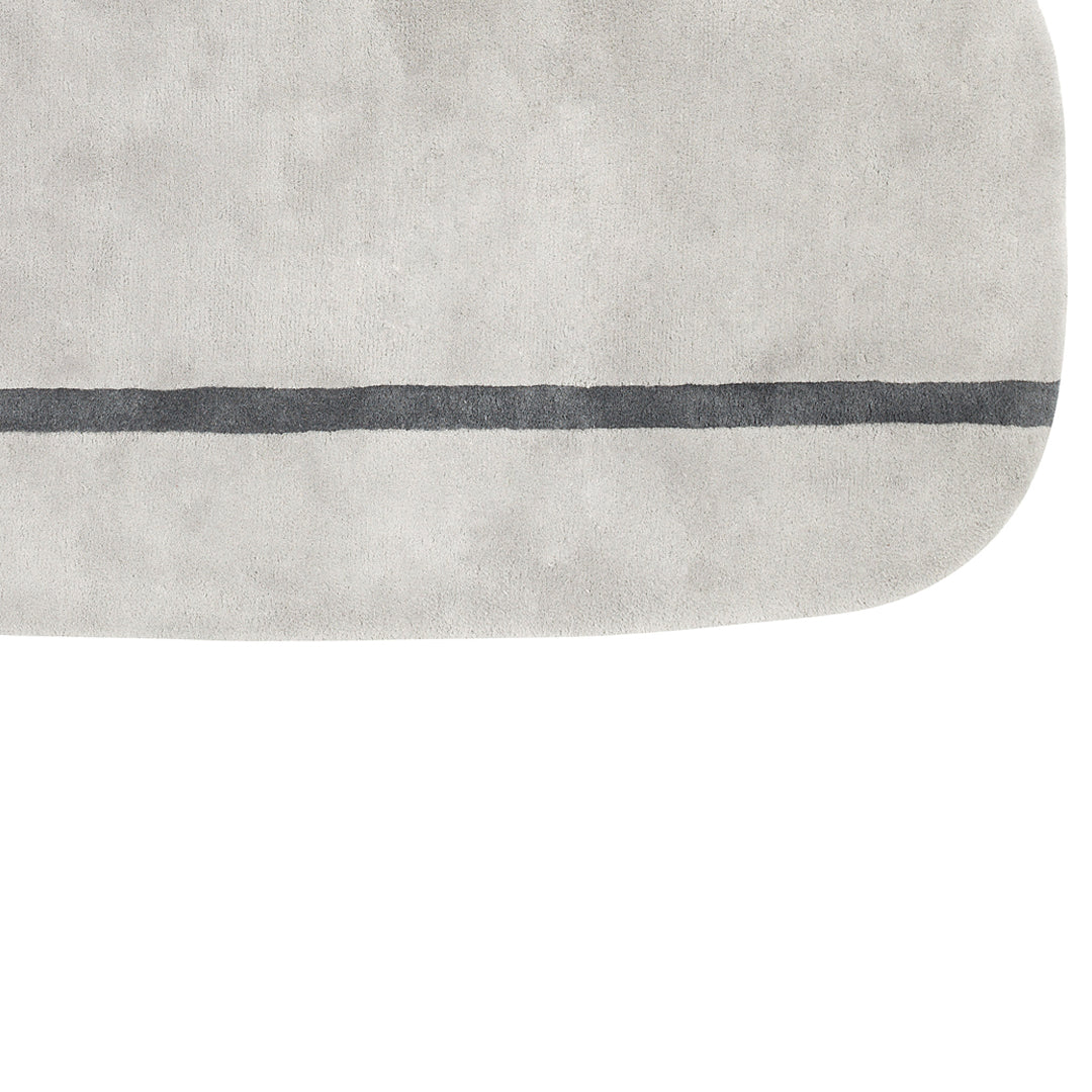 Light gray rug with a smooth texture and a contrasting dark gray line pattern. Perfect for modern decor.