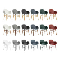 Multi-colored chairs in white, gray, green, dark gray, and red, with wood legs, featuring sleek contemporary designs.