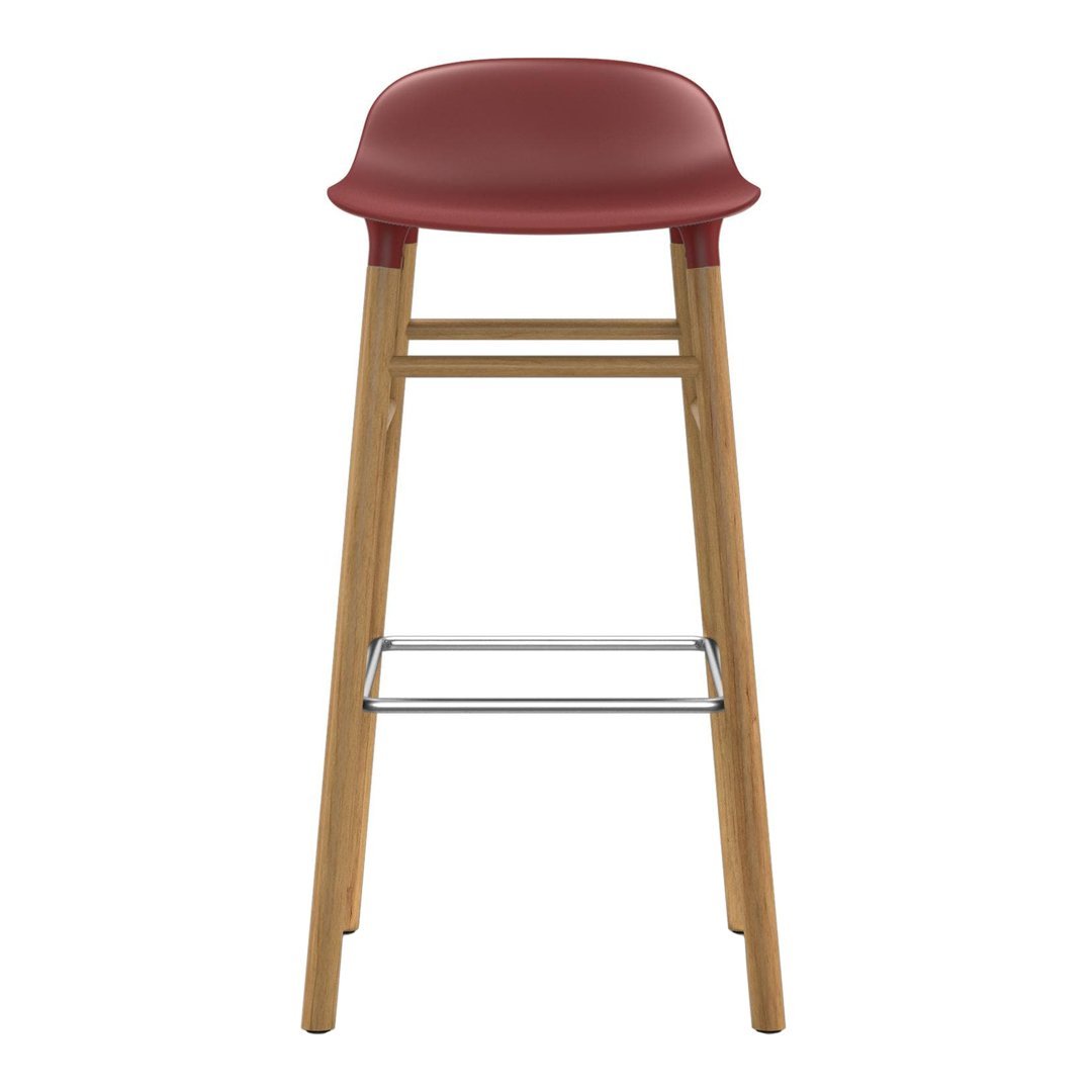 Red upholstered bar stool with natural wood legs and silver footrest, featuring a sleek, modern design.