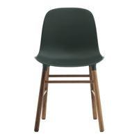 Modern dark green plastic chair with wooden legs, sleek design, perfect for contemporary decor.