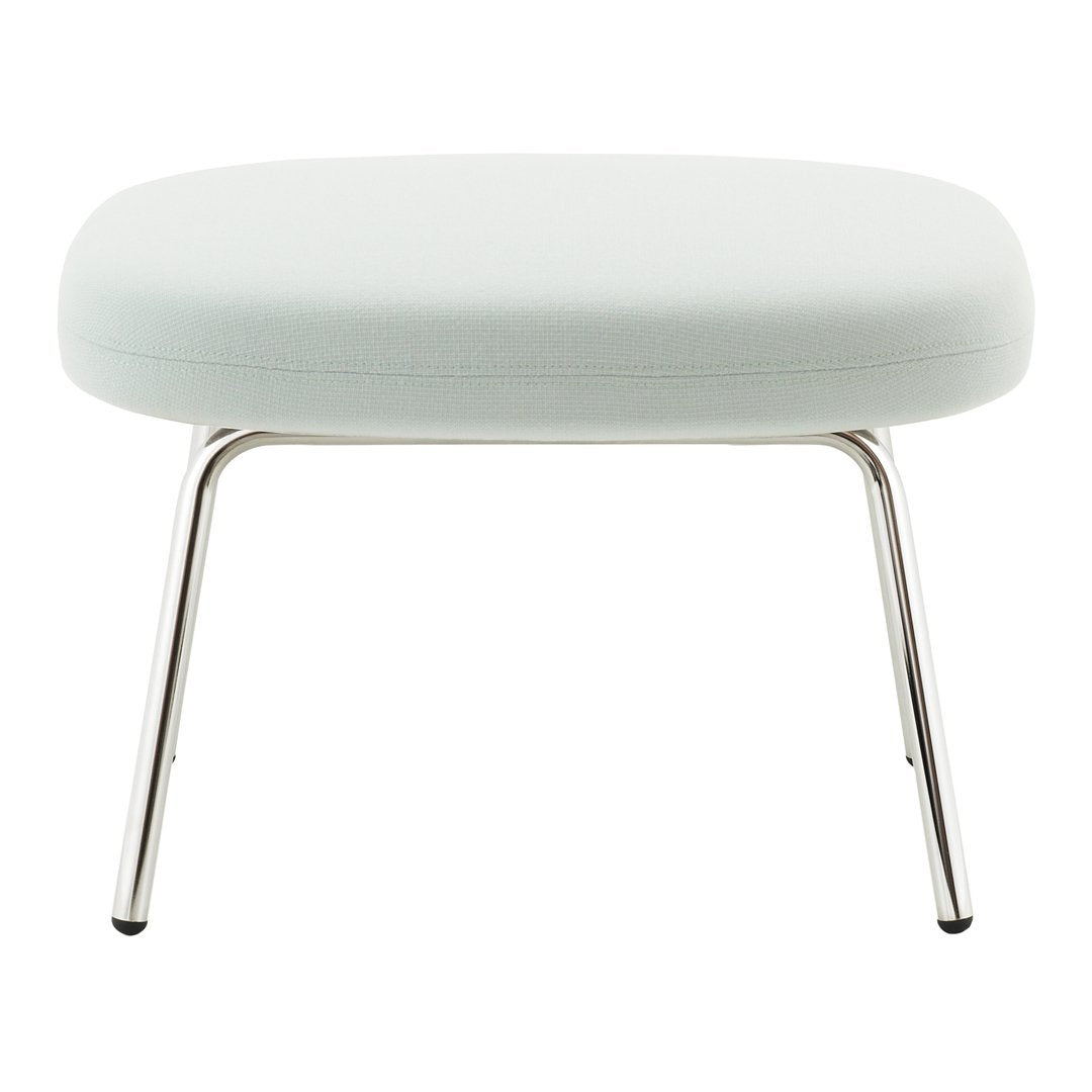 Light blue upholstered ottoman with a smooth, minimalist design and sleek chrome legs. Perfect for modern interiors.