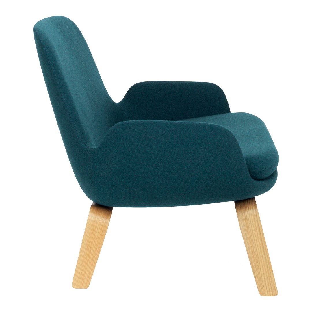 Teal upholstered chair with smooth curves and wooden legs, perfect for modern decor.