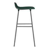 Green bar stool with a smooth, curved seating surface and sleek silver legs. Modern minimalist design.