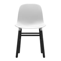 White modern chair with a sleek, smooth finish and contrasting black wooden legs. Minimalist design.