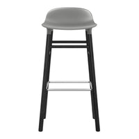 Gray plastic seat with a sleek black frame and silver footrest, minimalist design perfect for modern spaces.