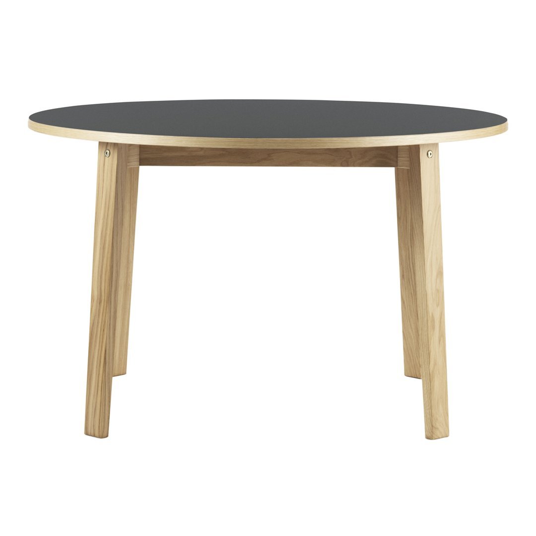 Round table with a sleek black top and natural wood legs, perfect for modern decor.