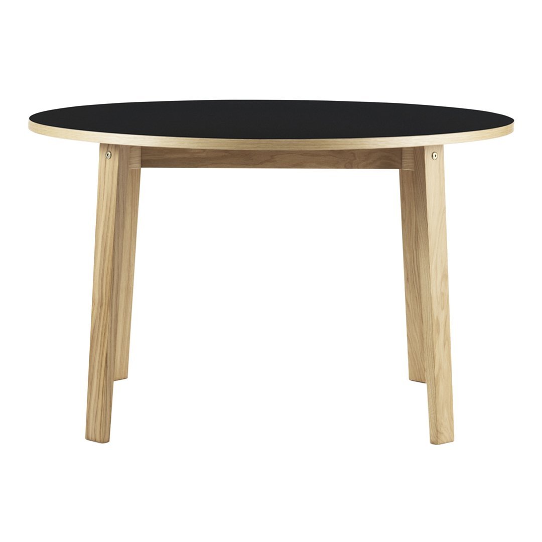 Round table with a black top and natural wood legs, showcasing a minimalist design. Perfect for modern decor.