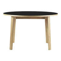 Round table with a black top and natural wood legs, showcasing a minimalist design. Perfect for modern decor.