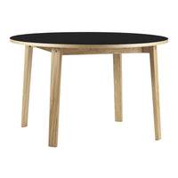 Round table featuring a black top and natural wood legs, offering a modern, minimalist design.