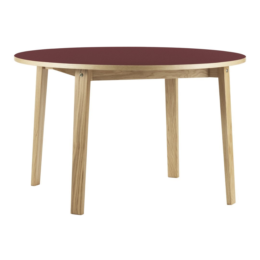 Round table with a rich burgundy top and natural wood legs, featuring a simple, modern design.
