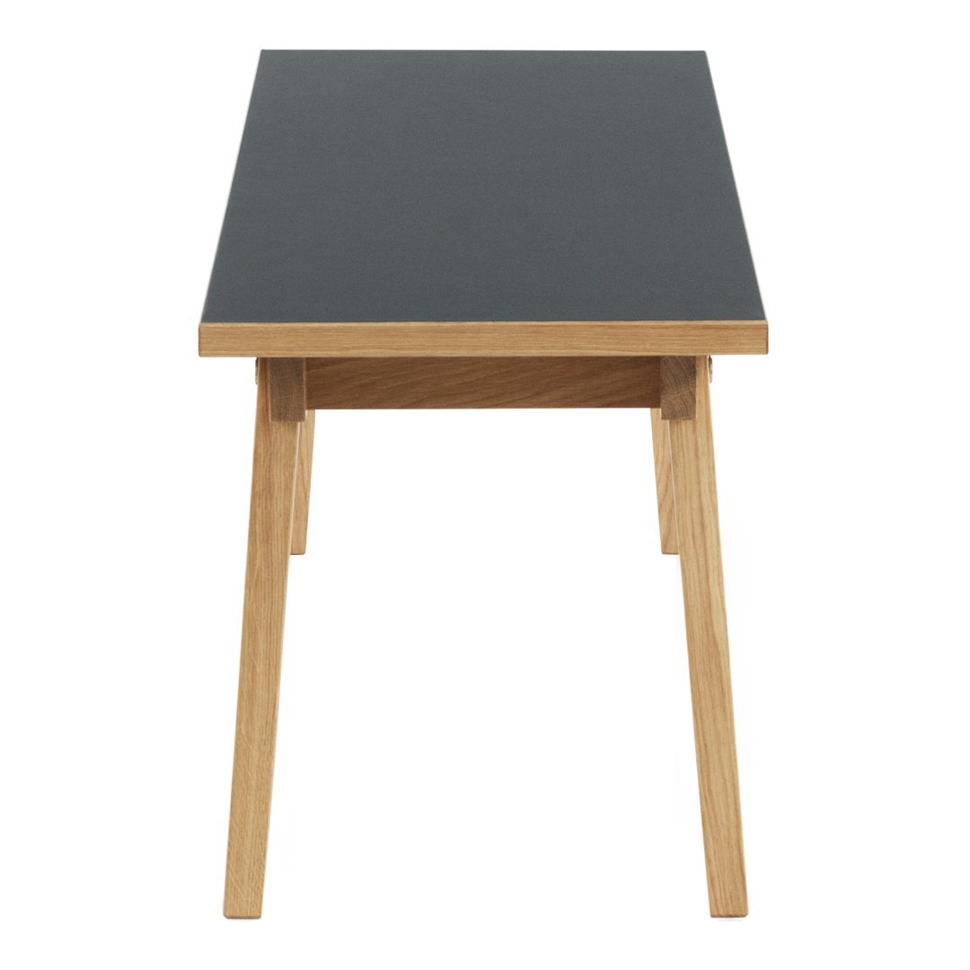 Modern table with a dark gray top and natural wood legs, showcasing a sleek, minimalist design.