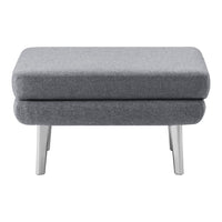 Gray upholstered ottoman with a sleek, minimalist design and silver legs, perfect for modern decor.