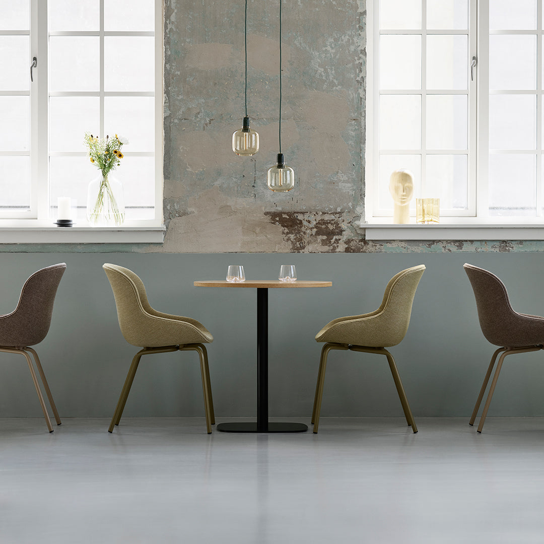 Elegant seating in soft beige and brown, complemented by a minimalistic table and textured gray wall. Modern decor.