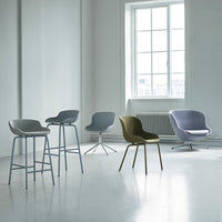 Modern chair collection featuring soft gray, olive green, and light purple tones in minimalist design.