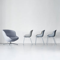 Gray armchair and four sleek gray chairs on a minimalist white background, showcasing modern design and subtle patterns.