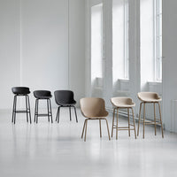 Six stylish chairs in black, dark gray, and light beige, featuring minimalist design and smooth, curved patterns.