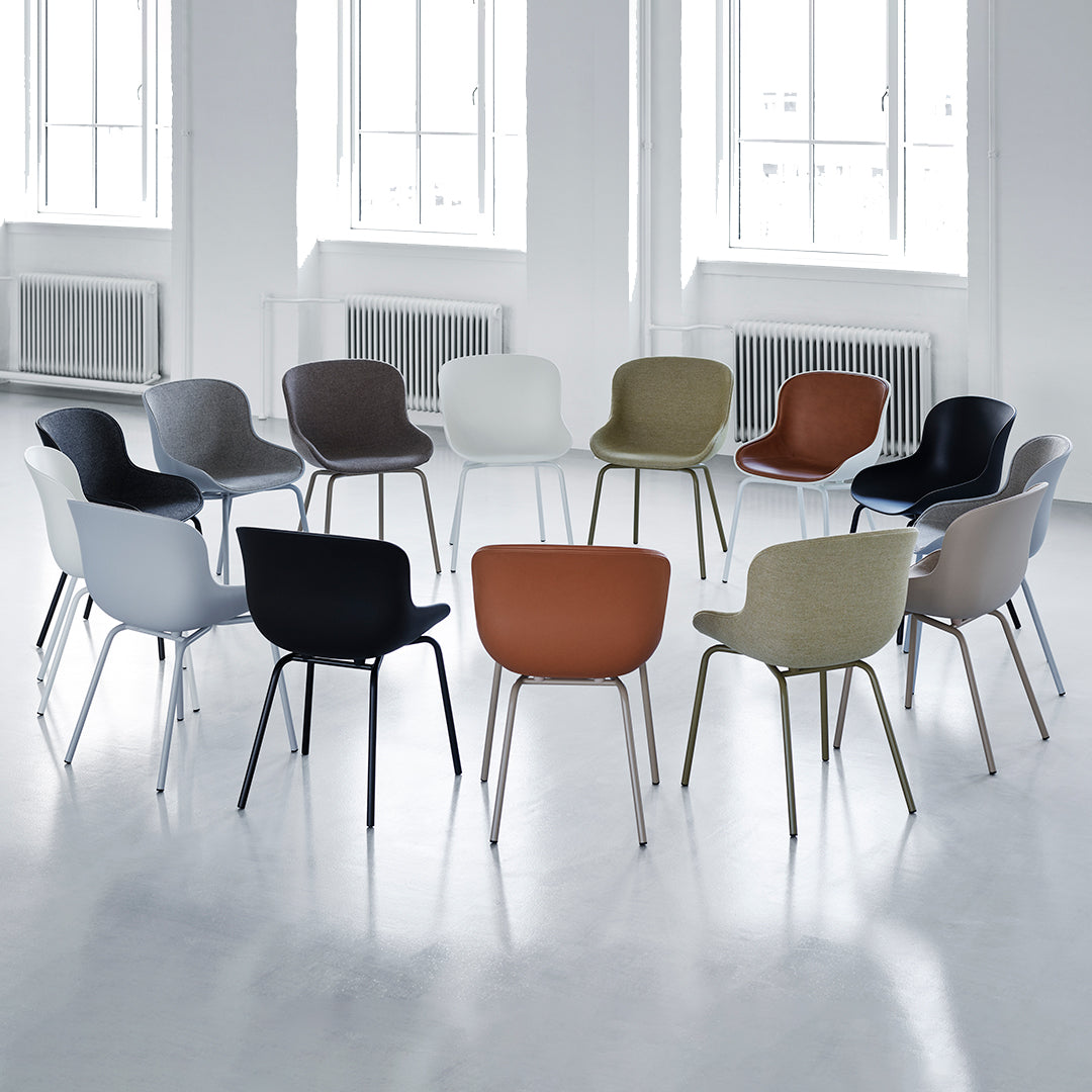 Colorful seating collection featuring pastel tones, muted earth shades, and bold black and brown patterns. Modern design.
