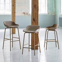 Set of three beige bar stools with smooth seats and metal legs in a minimalist, modern design.
