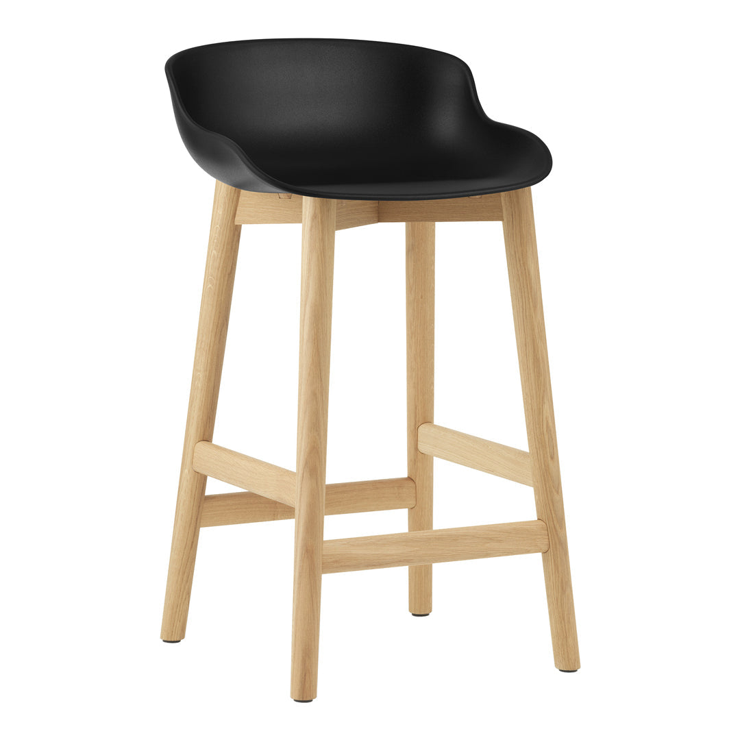 Black plastic seat bar stool with natural wooden legs, featuring a sleek, minimalist design.