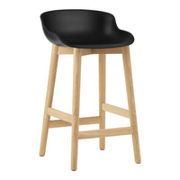 Black plastic seat bar stool with natural wooden legs, featuring a sleek, minimalist design.
