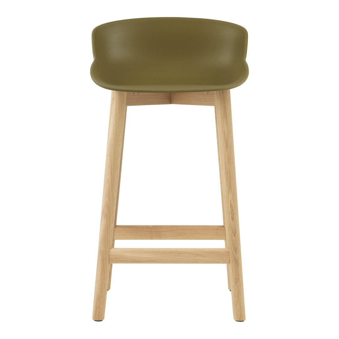 Olive green stool with a smooth seat and natural wooden legs, perfect for modern decor.