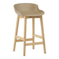 Beige plastic seat with smooth curves on a light wood frame, perfect for modern decor.