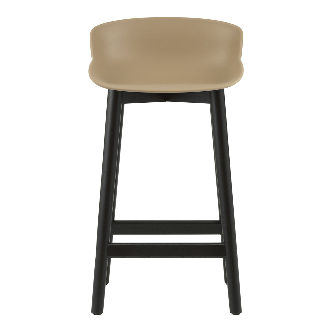 Tan seat with smooth curves on black wooden legs, featuring a modern minimalist design. Perfect for contemporary spaces.
