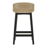 Tan seat with smooth curves on black wooden legs, featuring a modern minimalist design. Perfect for contemporary spaces.