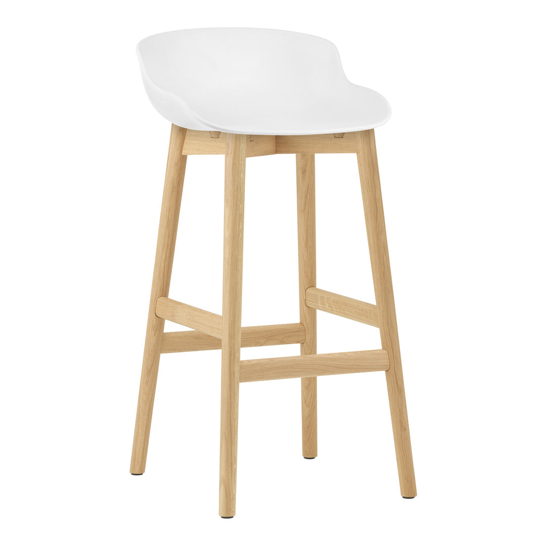 White modern bar stool with a smooth curved seat and natural wood legs for a minimalist look.