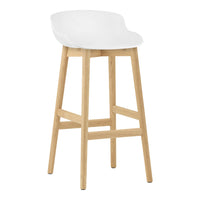 White modern bar stool with a smooth curved seat and natural wood legs for a minimalist look.