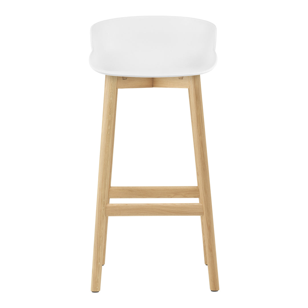 White cushioned stool with natural wood legs, minimalist design and smooth, clean lines. Perfect for modern spaces.