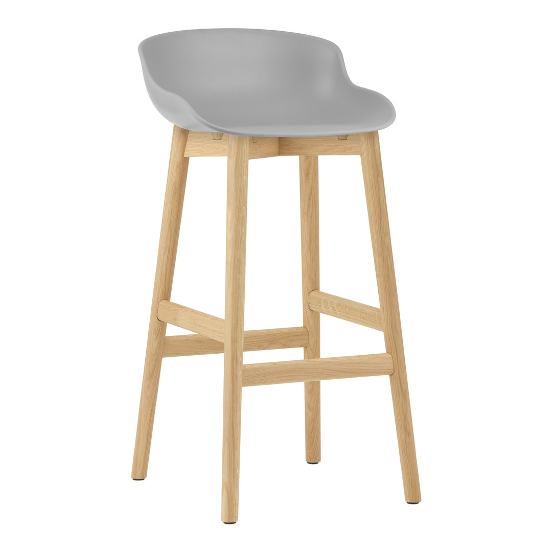 Gray bar stool with a minimalist design and natural wood legs. Perfect for modern home decor.