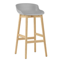 Gray bar stool with a minimalist design and natural wood legs. Perfect for modern home decor.