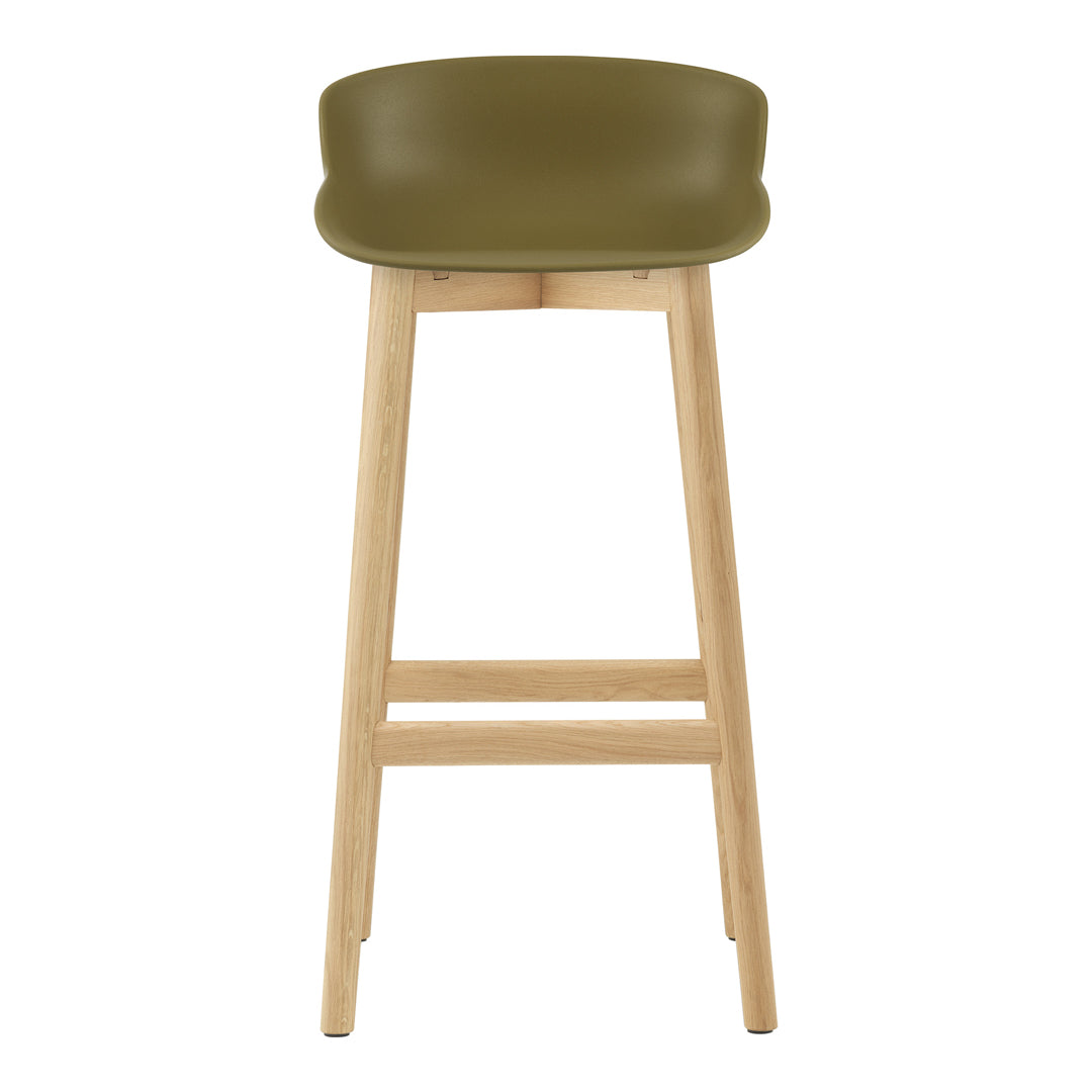 Green plastic bar stool with a minimalist design and natural wood legs. Ideal for modern interiors.