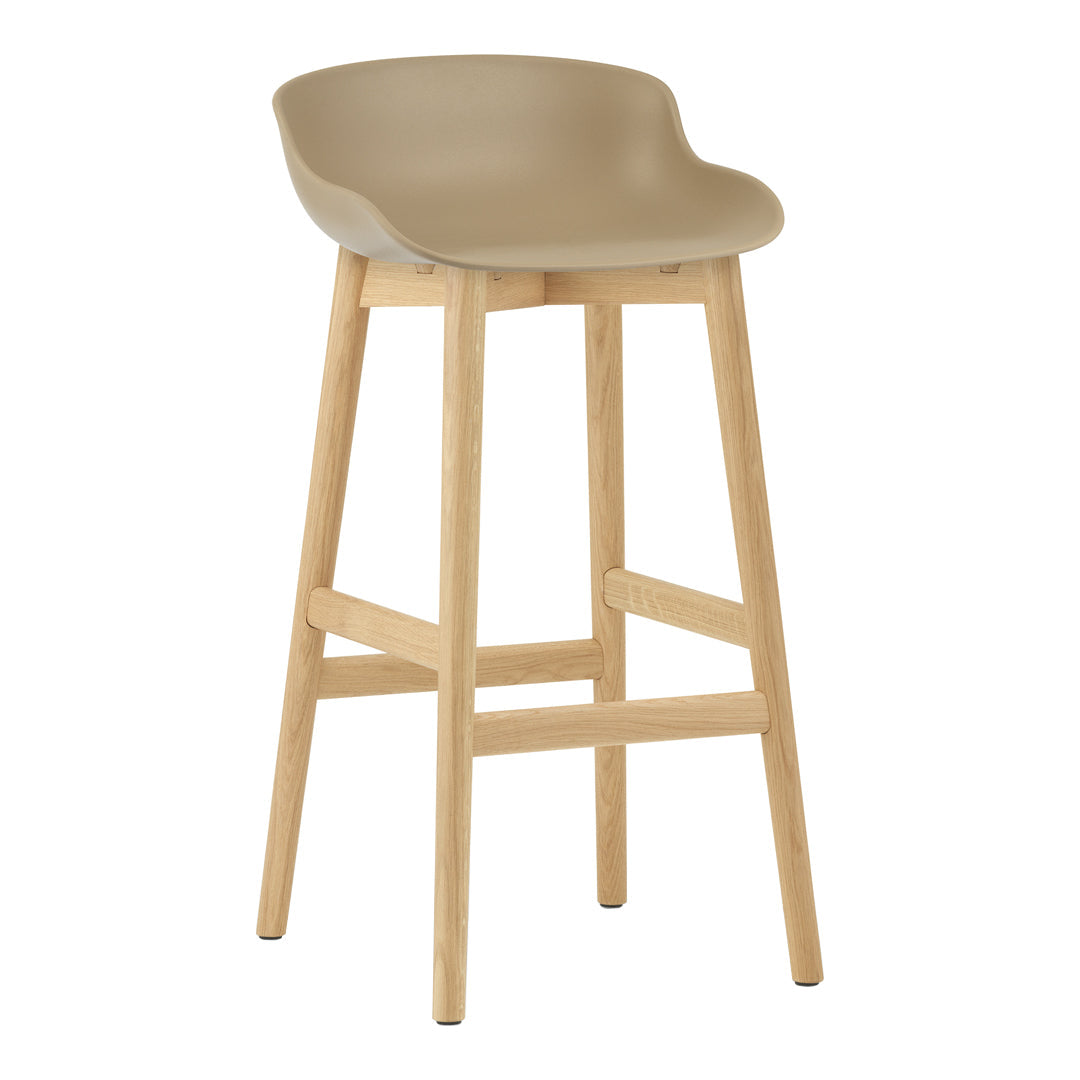 Tan plastic bar stool with a smooth edge design and natural wood legs, offering a modern and minimalist aesthetic.