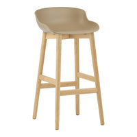 Tan plastic bar stool with a smooth edge design and natural wood legs, offering a modern and minimalist aesthetic.
