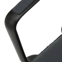 Close-up of a textured dark gray fabric with a matte black handle. Modern, minimalist design details.