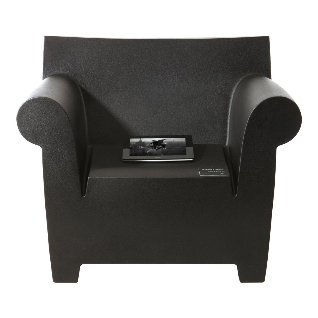 "Solid black armchair with a sleek, minimalist design and smooth surface, perfect for modern decor."