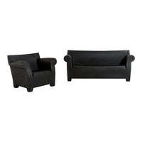 Black sofa and armchair set with smooth, minimalist design and solid color, ideal for modern home decor.