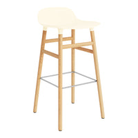 Light cream seat with natural wood legs and metal footrest, featuring a sleek, minimalist design.