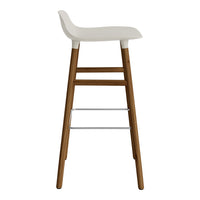 White upholstered seat with a natural wood frame and chrome accents, featuring a sleek, modern design.