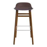 Brown bar stool with a sleek, minimalist design and wooden legs, featuring a smooth, contoured seat.