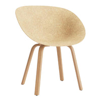 Light beige cork chair with smooth, curved seat and natural wood legs, showcasing minimalist design and texture.