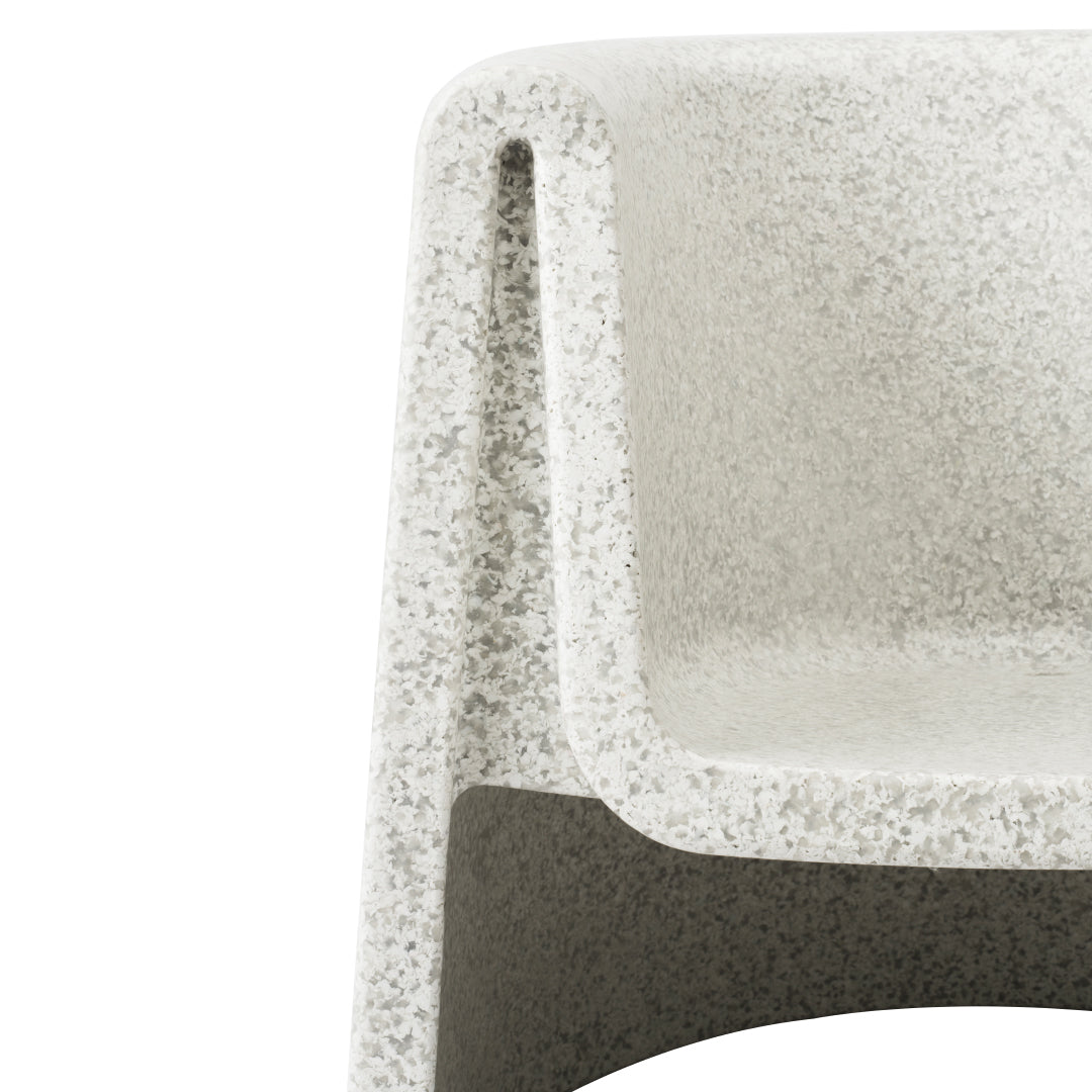 Textured gray and white speckled chair with sleek, modern design. Ideal for contemporary decor.