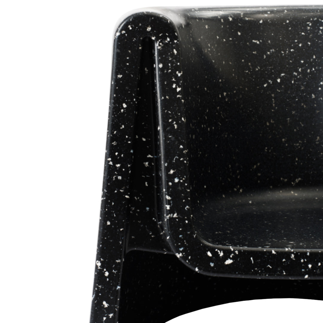Black chair with a speckled white pattern, offering a modern, sleek design. Ideal for contemporary spaces.