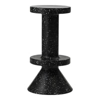 Black speckled accent table with a cylindrical top and conical base, featuring a modern and sleek design.
