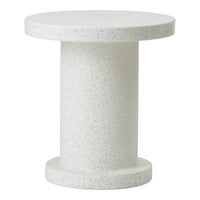 White speckled side table with a smooth round top and cylindrical base, perfect for minimalist decor.